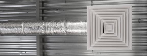 AC duct and vent below corrugated metal roof